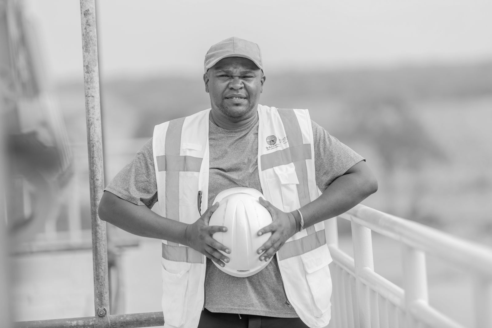 Roofing crew member holding a helmet